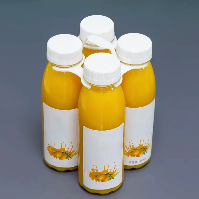 White 4-bottle plastic ring carrier securely holding four water bottles.