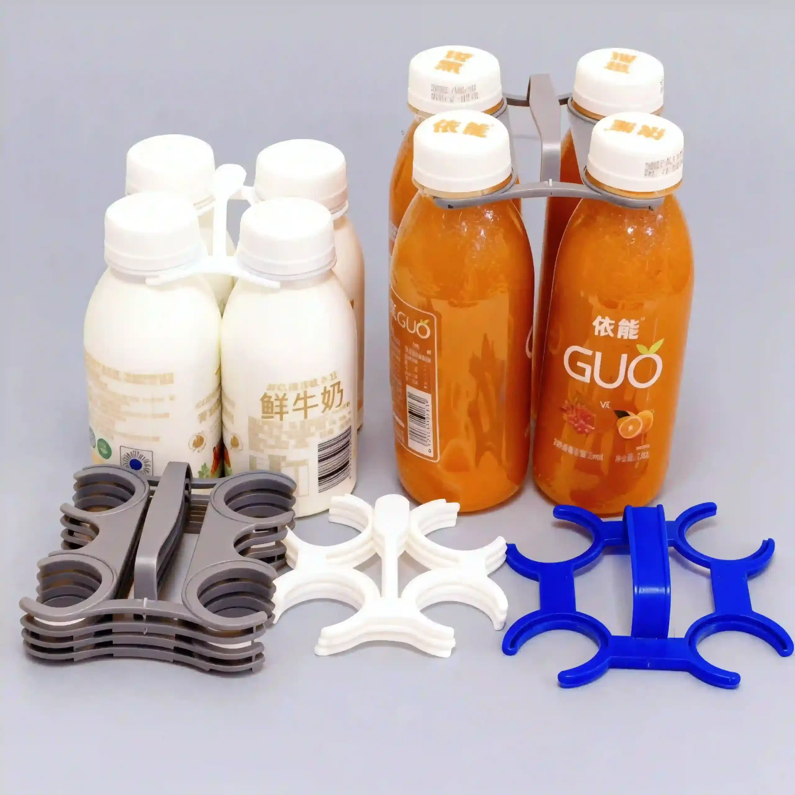 Close up detail of plastic beverage carrier rings fitted tightly on water bottle necks.