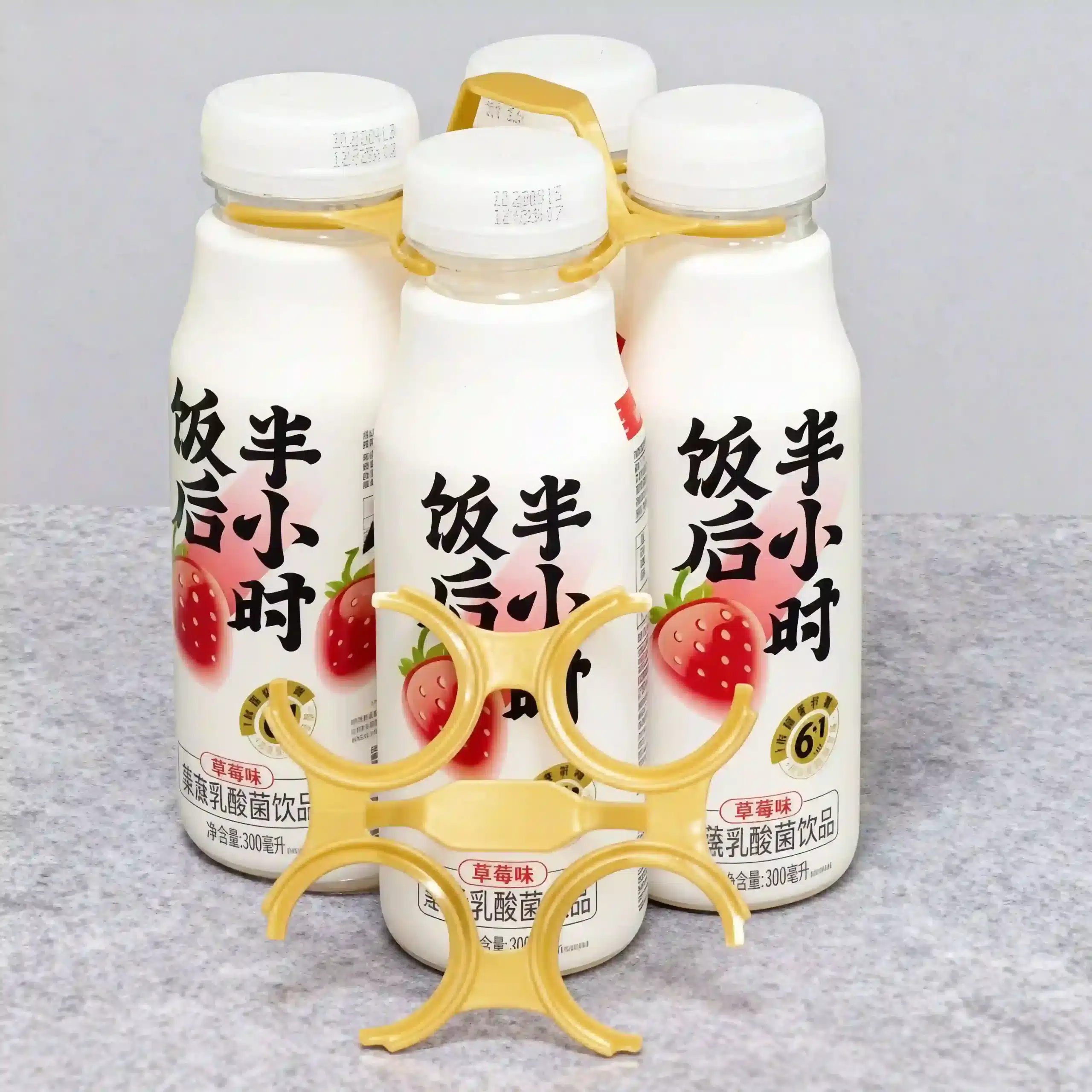 Isolated view of heavy-duty 4-bottle plastic carrier rings for bulk beverage packaging.